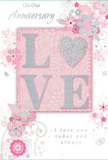 Laid out as if on a polished counter in a Carshalton flower shop, this anniversary card radiates gentle romance through its soft pinks, whites, and silvery details. At the centre, the word LOVE is embossed in raised letters, each one coated with a subtle glitter that sparkles just enough to catch the eye without overwhelming it. The texture seems lightly grainy and tactile, reminiscent of the finish on luxury stationery. Behind these letters, a blush-pink rectangle provides a warm, flattering backdrop, standing slightly deeper in tone than the rest of the card's pale pink surface. Around the central word, stylized blossoms and curling vines sweep and swirl, their lines delicate and flowing, like the loose outlines of a bouquet design sketched before real stems are gathered for delivery around the Carshalton ponds. The flowers themselves are soft and romantic, shaded in blush and ivory with touches of dove grey and hints of silver, suggesting either fine foil or metallic ink that picks up the light. These botanical elements are spaced thoughtfully, leaving room for the background colour to show through and give the artwork a light, airy feel. Elegant, gently looping script text weaves into the layout, offering loving anniversary sentiments that feel personal and heartfelt, as if written by hand. Overall, the card conveys a sense of tender celebration and lasting devotion-a paper equivalent of a pastel anniversary bouquet, created with the same care and attention a local Carshalton florist brings to every special delivery.